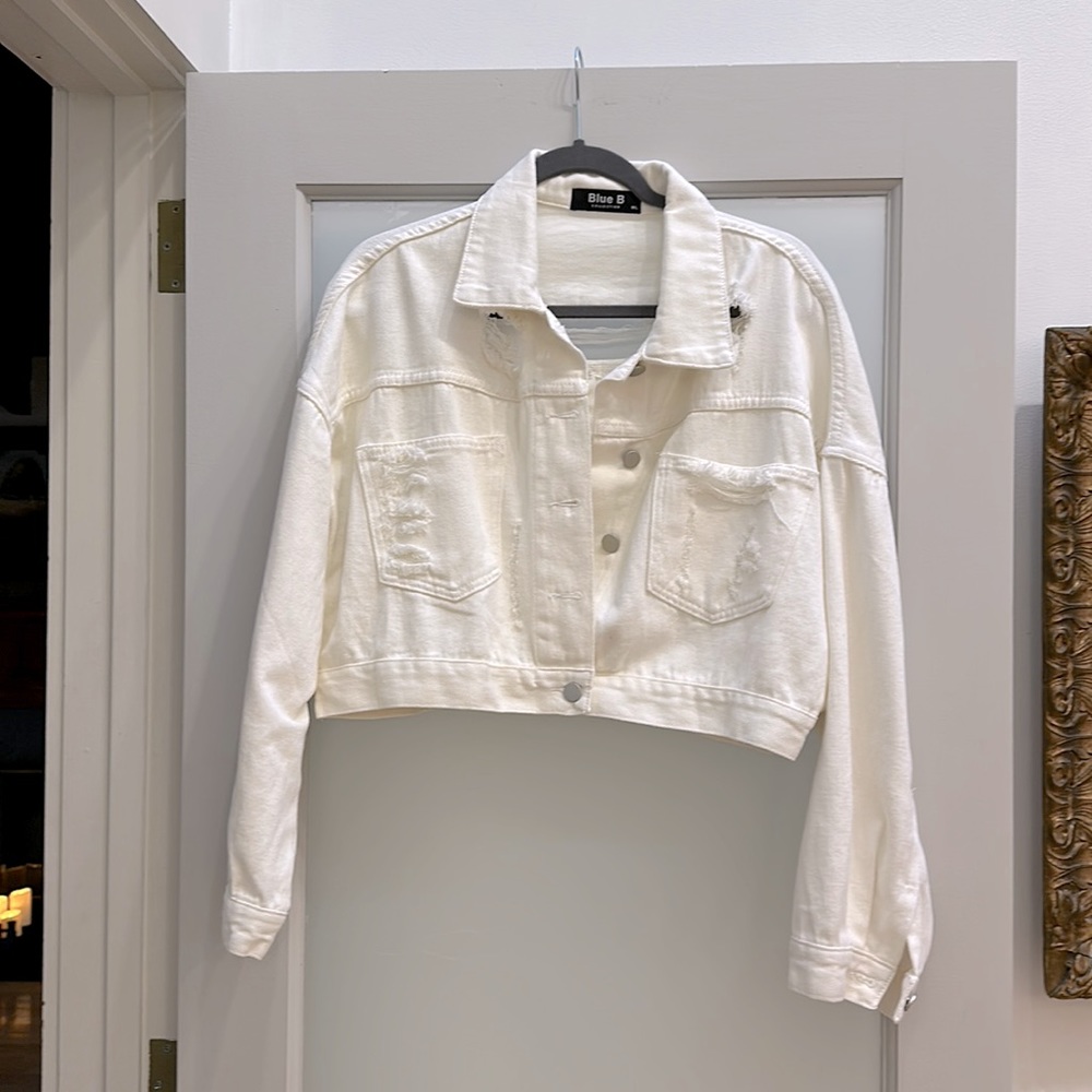 White distressed denim jacket with rhinestone trim